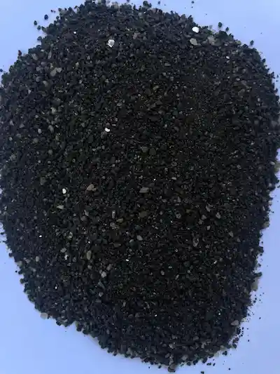 Tantalum concentrate (Ta2O5) raw ore with granular texture on white background